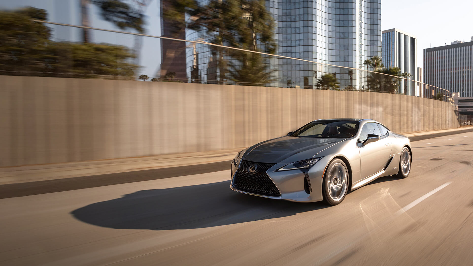 Silver Lexus LC 500h being driven on the road.